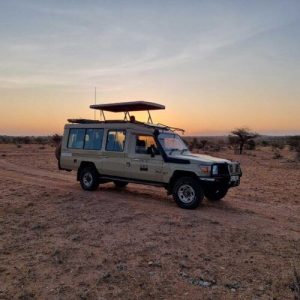 Safari 4X4 Vehicle Silhouetted Against An African Sunset